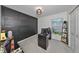 Home office with dark-paneled wall and desk at 5429 Rainwood Meadows Dr, Apollo Beach, FL 33572