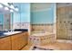 Bathroom with soaking tub, shower, and granite vanity at 700 N Osceola Ave # 702, Clearwater, FL 33755