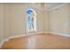 Bright bedroom featuring hardwood floors and arched window at 700 N Osceola Ave # 702, Clearwater, FL 33755