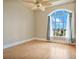 Spacious bedroom with hardwood floors and a large arched window with city views at 700 N Osceola Ave # 702, Clearwater, FL 33755