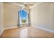 Bright bedroom featuring hardwood floors and a large arched window with water views at 700 N Osceola Ave # 702, Clearwater, FL 33755