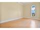 Bright bedroom with hardwood floors and arched window offering water views at 700 N Osceola Ave # 702, Clearwater, FL 33755