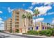 Tan colored building exterior, palm trees, and blue sky at 700 N Osceola Ave # 702, Clearwater, FL 33755