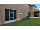 View of backyard with screened patio and AC unit at 12820 Belvedere Song Way, Riverview, FL 33578