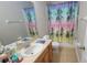 Charming bathroom with a shower/tub combo and colorful shower curtain at 12820 Belvedere Song Way, Riverview, FL 33578