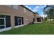 Back of house with screened patio and grassy area at 12820 Belvedere Song Way, Riverview, FL 33578