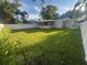 Spacious backyard featuring a large grassy area and screened porch at 1574 Ewing Ave, Clearwater, FL 33756