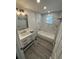 Renovated bathroom with bathtub and modern vanity at 1574 Ewing Ave, Clearwater, FL 33756