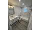 Updated bathroom with bathtub and modern vanity at 1574 Ewing Ave, Clearwater, FL 33756