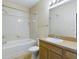 Bathroom with tub, toilet and wood vanity at 10121 Courtney Palms Blvd # 204, Tampa, FL 33619