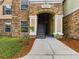 Building entrance with stairs and stone facade at 10121 Courtney Palms Blvd # 204, Tampa, FL 33619