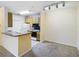 Kitchen with light wood cabinets and breakfast bar at 10121 Courtney Palms Blvd # 204, Tampa, FL 33619