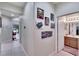 Hallway with light walls, tile floors, and artwork at 242 Shell Falls Dr, Apollo Beach, FL 33572