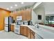 Modern kitchen with stainless steel appliances and orange accent wall at 242 Shell Falls Dr, Apollo Beach, FL 33572