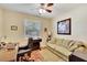 Home office with desk, comfortable sofa, and hardwood floors at 242 Shell Falls Dr, Apollo Beach, FL 33572