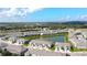 Aerial view of the community, showcasing the lake and townhomes at 8762 Falling Blue Pl, Riverview, FL 33578