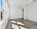 Bedroom with wood-look floors and access to a bathroom at 6179 Hidden Branch Dr, Apollo Beach, FL 33572