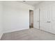 Bedroom with carpet, double doors, and access to a hallway at 6179 Hidden Branch Dr, Apollo Beach, FL 33572
