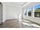 Bright bedroom with wood-look floors and three windows at 6179 Hidden Branch Dr, Apollo Beach, FL 33572
