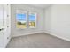 Bedroom with carpet, two windows, and a door at 6179 Hidden Branch Dr, Apollo Beach, FL 33572