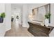 Bright and airy entryway with wood-look floors and stylish console table at 6179 Hidden Branch Dr, Apollo Beach, FL 33572