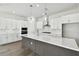 Modern kitchen with white cabinets, quartz countertops, and stainless steel appliances at 6179 Hidden Branch Dr, Apollo Beach, FL 33572