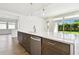 Kitchen island with sink, dishwasher and white quartz countertop at 6179 Hidden Branch Dr, Apollo Beach, FL 33572