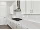 Sleek kitchen with white cabinets, gas cooktop and quartz countertops at 6179 Hidden Branch Dr, Apollo Beach, FL 33572