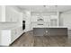 Spacious kitchen featuring white cabinets, a large island, and wood-look floors at 6179 Hidden Branch Dr, Apollo Beach, FL 33572