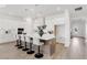Modern kitchen with white cabinets and large island with seating at 6179 Hidden Branch Dr, Apollo Beach, FL 33572