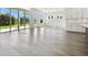 Open living area with hardwood floors and access to the backyard at 6179 Hidden Branch Dr, Apollo Beach, FL 33572