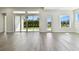 Bright living room with hardwood floors and sliding glass doors to backyard at 6179 Hidden Branch Dr, Apollo Beach, FL 33572