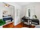 View of bedroom from adjacent room, featuring hardwood floors and a bed at 120 W Hiawatha St, Tampa, FL 33604