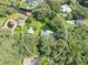 Aerial view of a home on a wooded lot with a detached structure and expansive yard at 10824 Palmetto St, Riverview, FL 33569