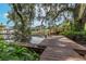 Wooden dock with lush foliage and calm water at 10824 Palmetto St, Riverview, FL 33569