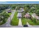 Aerial view of a house with a driveway and a green lawn at 1311 E Church St, Plant City, FL 33563