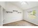 Bedroom with wood-look floors, ceiling fan, and built-in shelving at 8929 Cashella Ct, Trinity, FL 34655