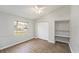 Bedroom with wood-look floors, ceiling fan, and built-in shelving at 8929 Cashella Ct, Trinity, FL 34655