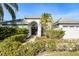 House exterior showcasing a lush front yard and double-door entry at 8929 Cashella Ct, Trinity, FL 34655