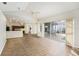 Bright living room with wood-look floors and sliding glass doors to the pool area at 8929 Cashella Ct, Trinity, FL 34655