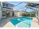 Inviting screened pool with covered patio and outdoor kitchen at 8929 Cashella Ct, Trinity, FL 34655