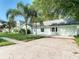 Light teal single story house with mature landscaping and a spacious driveway at 2229 Arch Mcdonald Dr, Dover, FL 33527