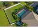 Aerial view of backyard featuring screened-in pool, privacy fence, and lush green lawn at 4505 Golden Gate Cv, Bradenton, FL 34211