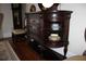 Dark wood buffet with glass-front cabinet and drawers at 5909 Menorca Ln, Apollo Beach, FL 33572