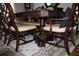 Elegant formal dining room with ornate wood table and chairs at 5909 Menorca Ln, Apollo Beach, FL 33572