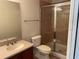 Bathroom with glass enclosed shower, modern toilet and sink at 8504 Brushleaf Way, Tampa, FL 33647