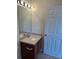 Bathroom with a vanity sink, a mirror, and a door at 8504 Brushleaf Way, Tampa, FL 33647