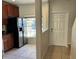 Kitchen area with stainless steel refrigerator with adjacent doorway entrance at 8504 Brushleaf Way, Tampa, FL 33647