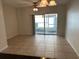 Bright living room featuring tile floors and sliding glass doors at 8504 Brushleaf Way, Tampa, FL 33647