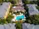 An aerial view of resort-style community, featuring a large pool, lush landscaping, and colorful buildings at 4207 S Dale Mabry Hwy # 12204, Tampa, FL 33611